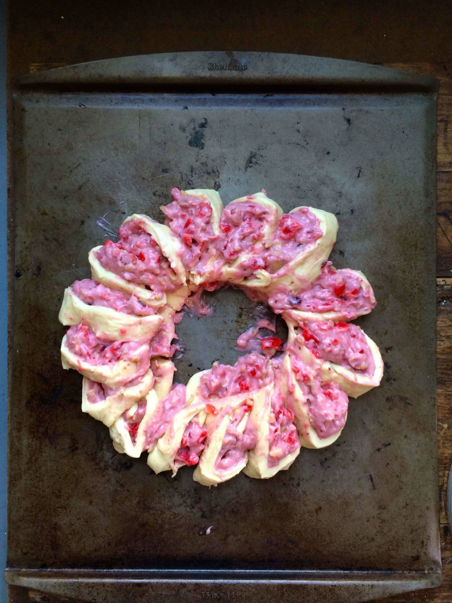 Pink bread dough on a pan.