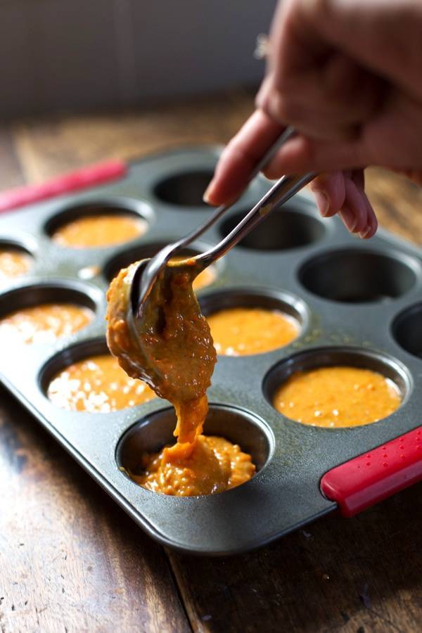 Carrot cake batter in muffin tins.