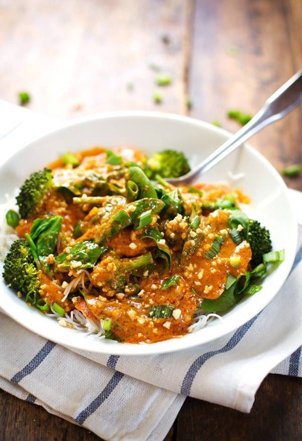 Thai Curry Sauce in a bowl over noodles and broccoli.