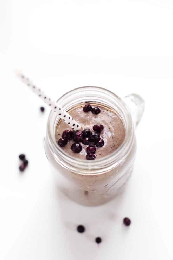 Honey and Wild Blueberry Smoothie in a jar topped with blueberries.