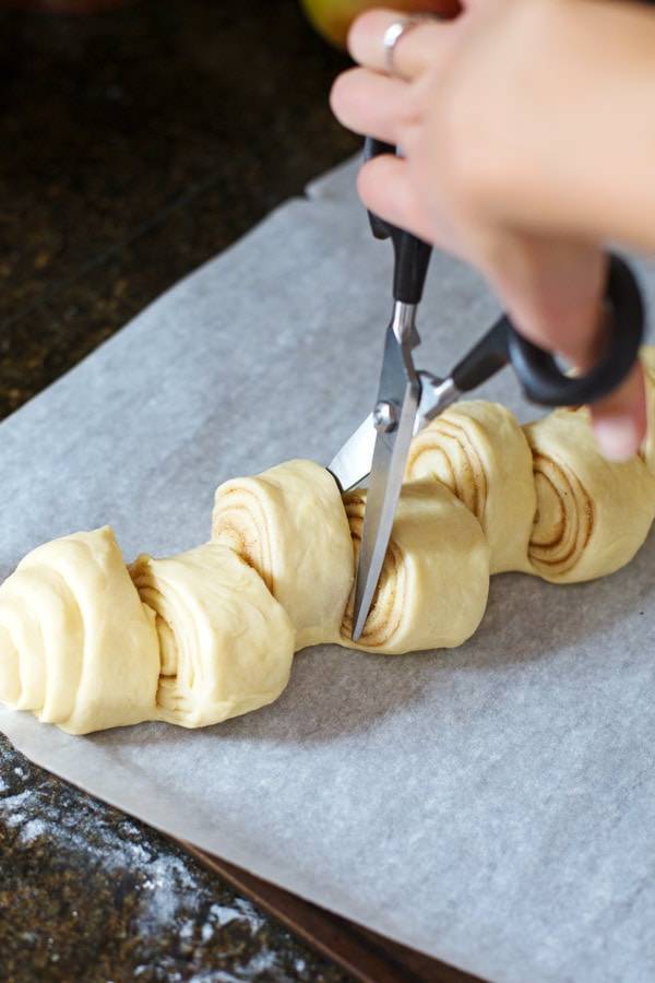 Cinnamon dough cut with scissors.