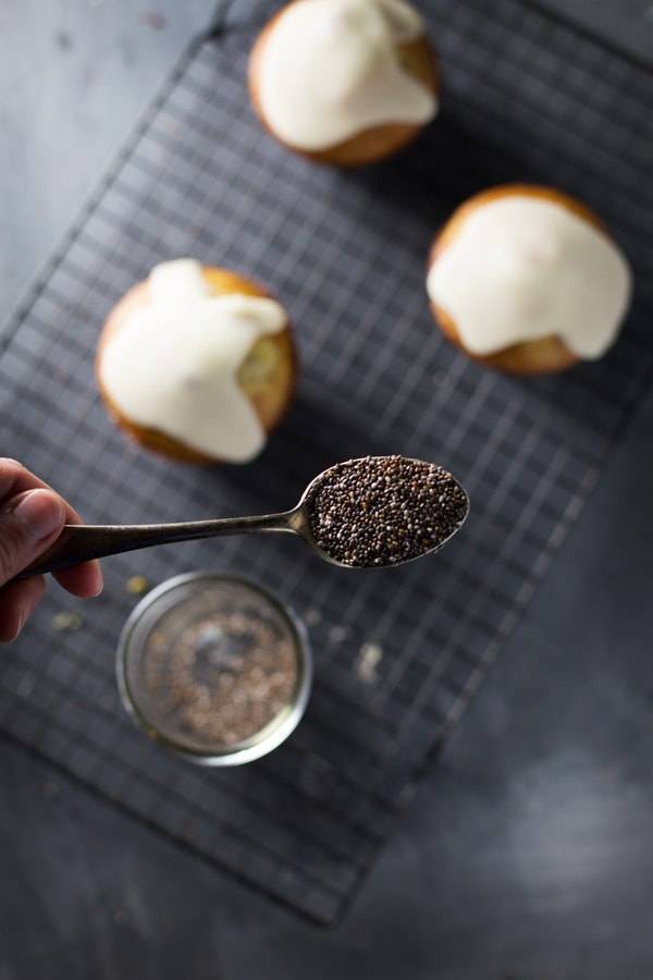 Lemon muffins with poppy seeds on a spoon.