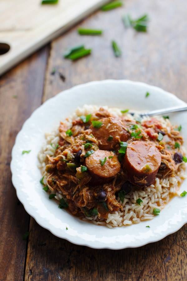 Chicken and Sausage over rice on a white plate.