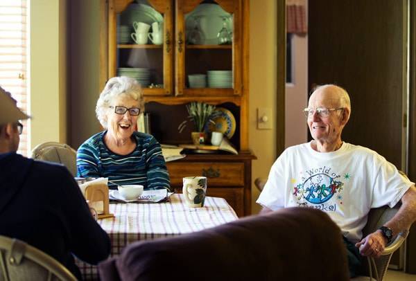 Elderly couple laughing.