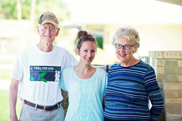 Three people smiling.