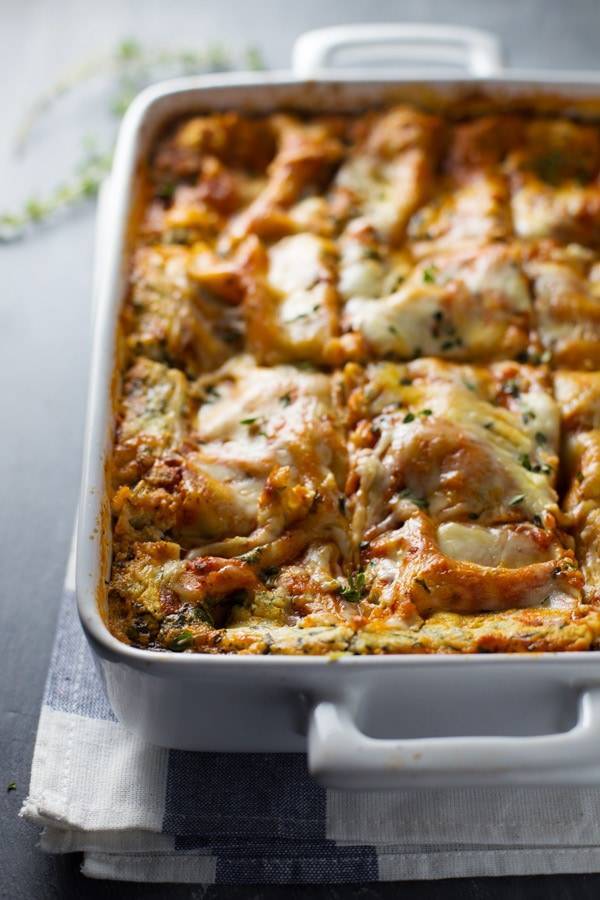 This Skinny Spinach Lasagna has thick layers of sauce, noodles, ricotta, spinach, and Mozzarella - queue the mouth watering! | pinchofyum.com