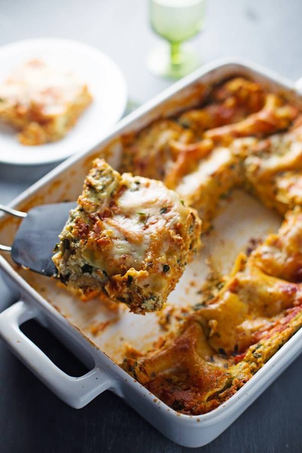 This Skinny Spinach Lasagna has thick layers of sauce, noodles, ricotta, spinach, and Mozzarella - queue the mouth watering! | pinchofyum.com