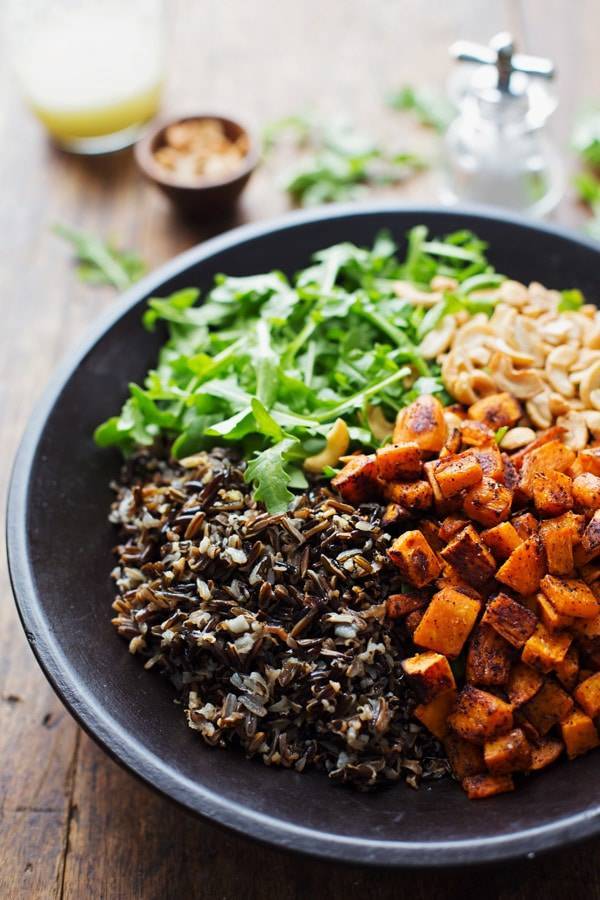 Roasted Sweet Potato, Wild Rice, and Arugula Salad in a bowl.