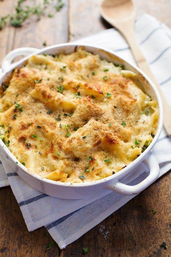 Garlic Parmesan Chicken Lasagna Bake in a white dish with a wooden spoon.