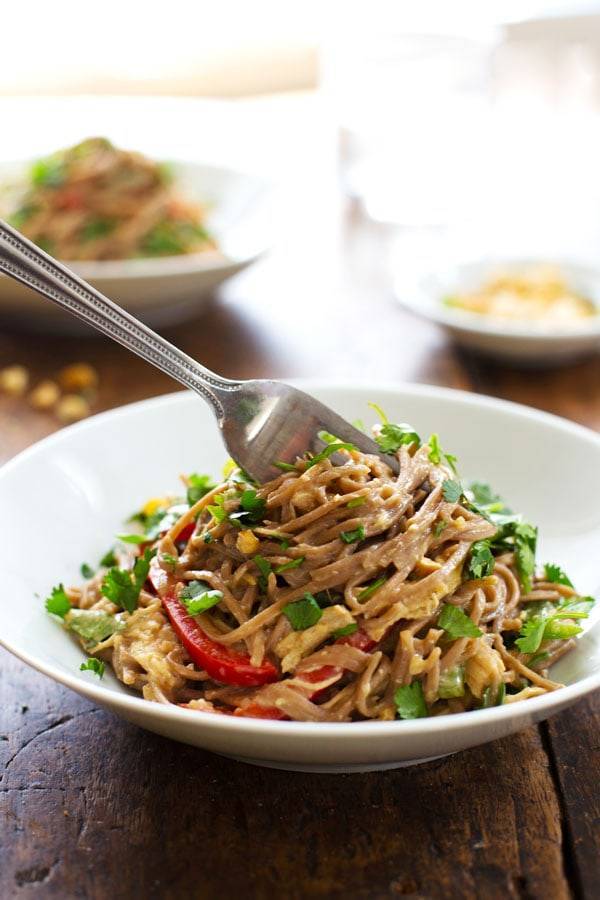 Peanut Chicken Soba Noodle Salad in a white bowl with a fork.