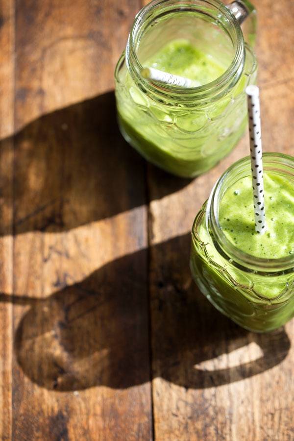 Two green smoothies in jars.