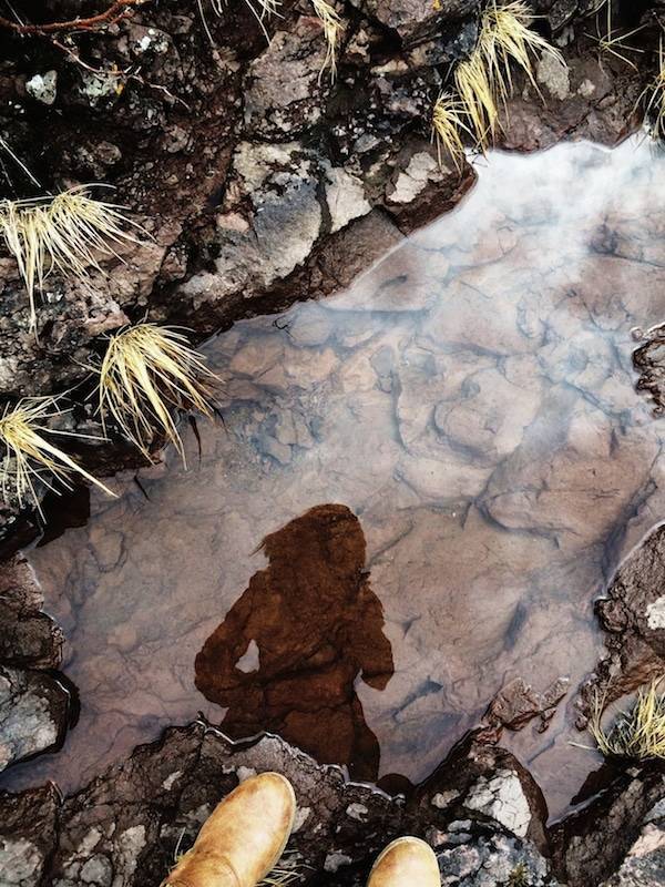 Reflection of a woman in a pond.