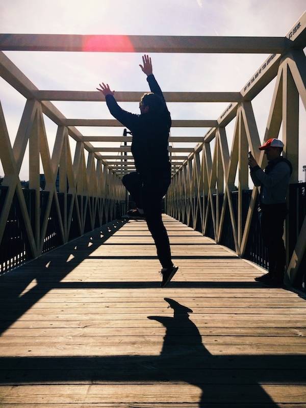 Man jumping on a bridge.