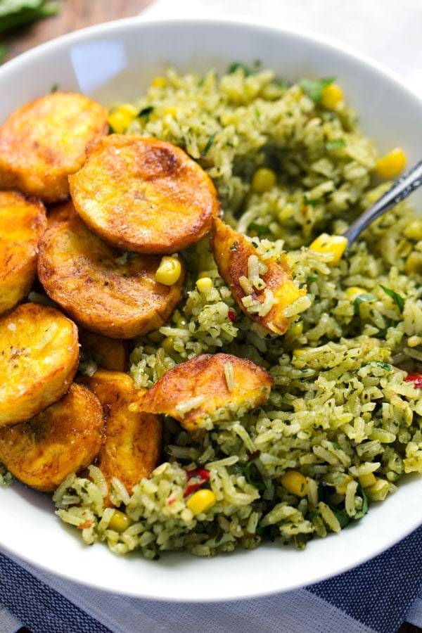 Green Mexican Rice with Corn in a white bowl.