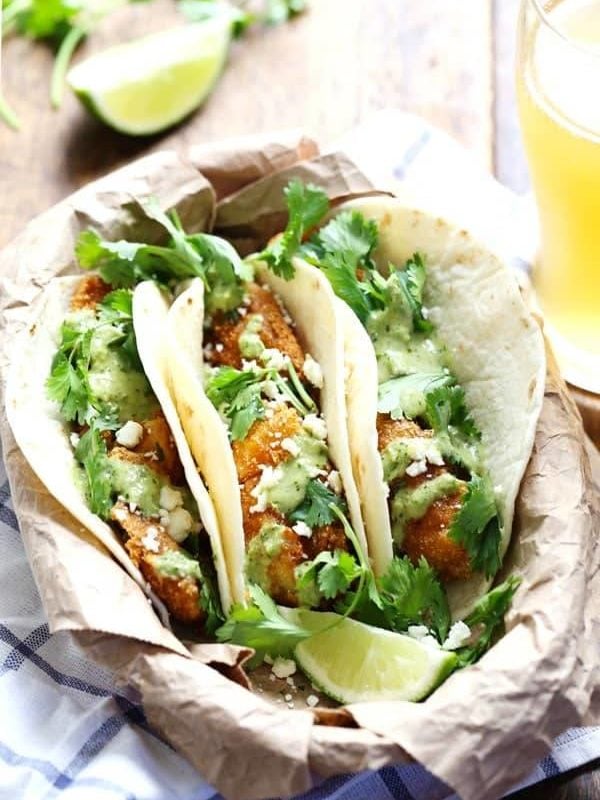 Crispy Fish Tacos with Jalapeño Sauce - beer-battered with a cornmeal crust for an extra yummy texture, plus the spicy-cool combo of that creamy jalapeño sauce. Summer food! | pinchofyum.com