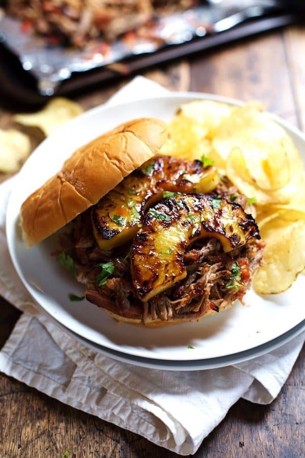 Grilled Pineapple Pork Sandwich on a plate with chips.