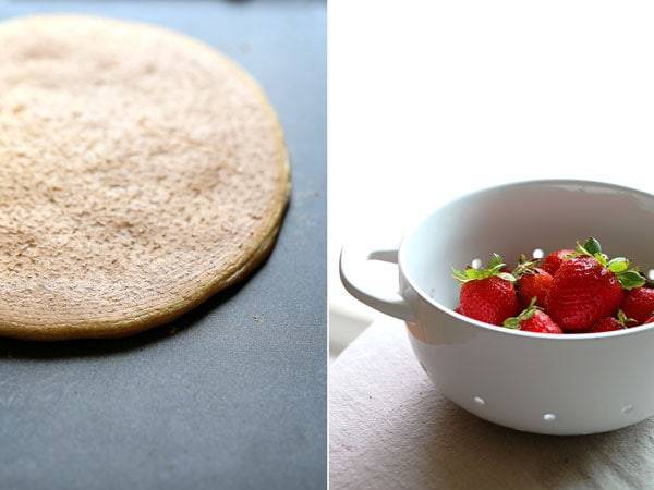 Pancake on a skillet and berries in a bowl.