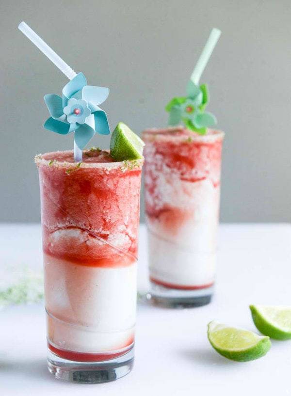 Red and white smoothies with straws.