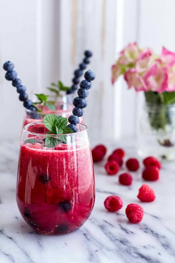 Purple smoothie with blueberries and raspberries.
