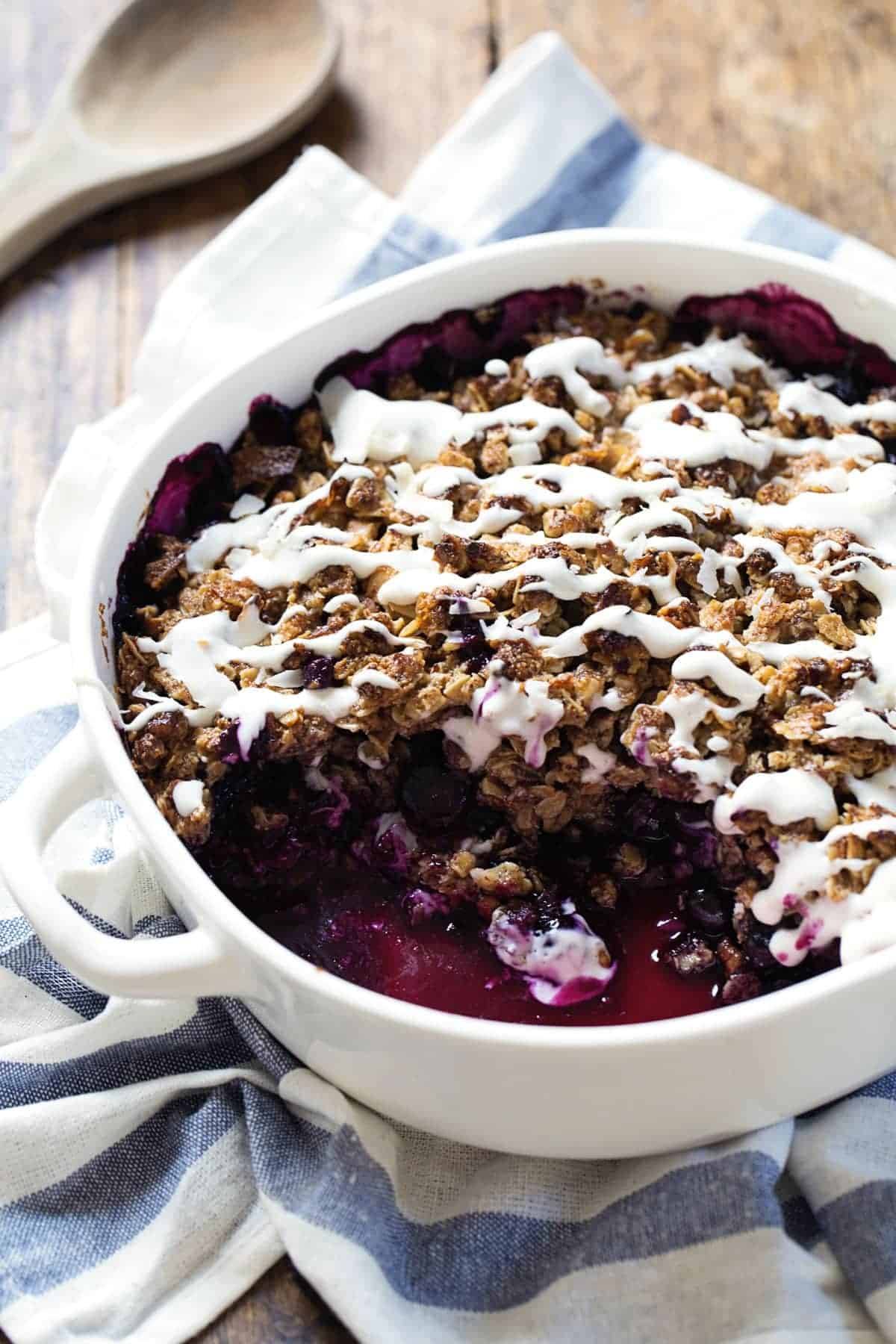 Simple Oat and Blueberry Crisp in a white baking dish.