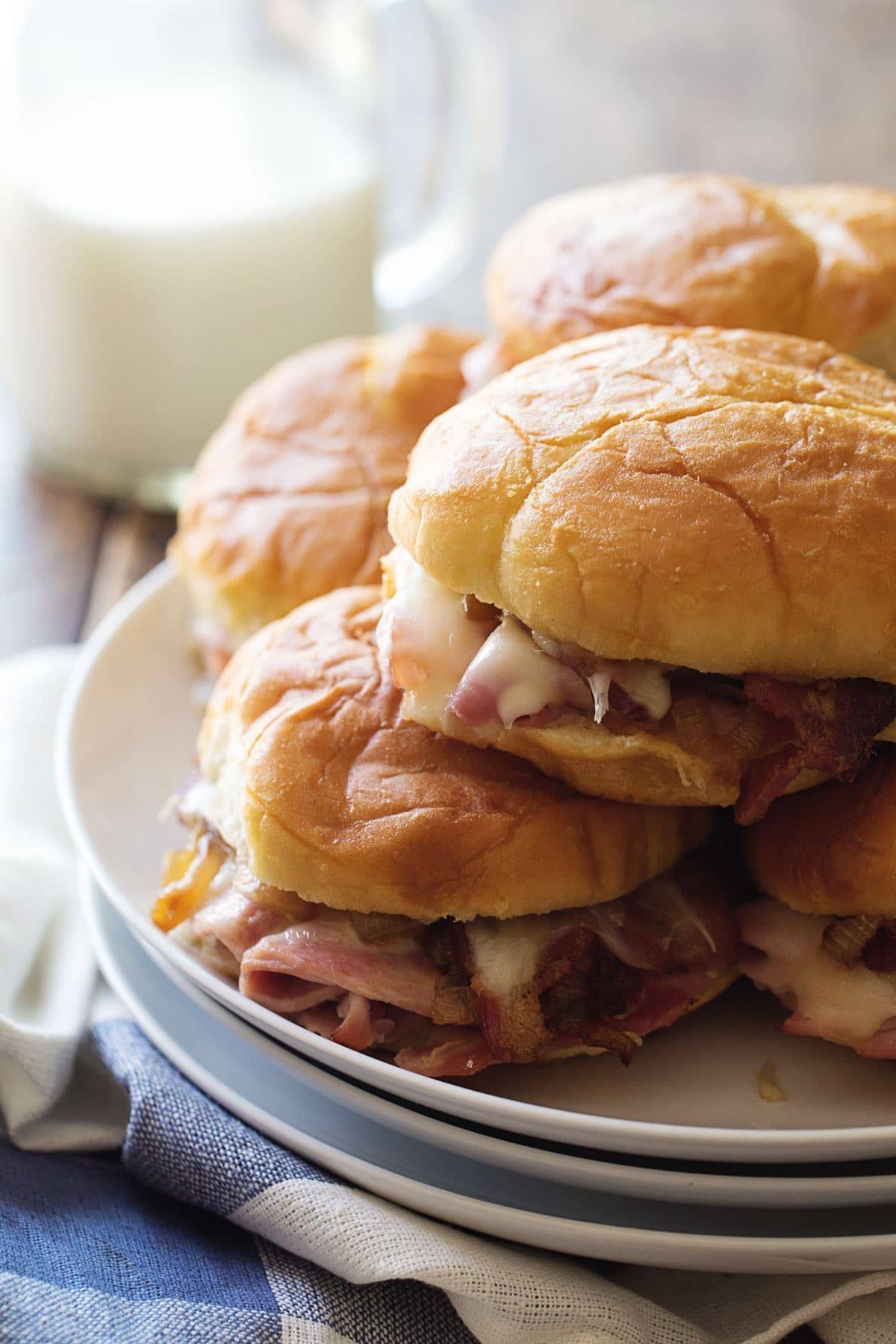Ham and Cheese Sandwiches stacked on a plate.