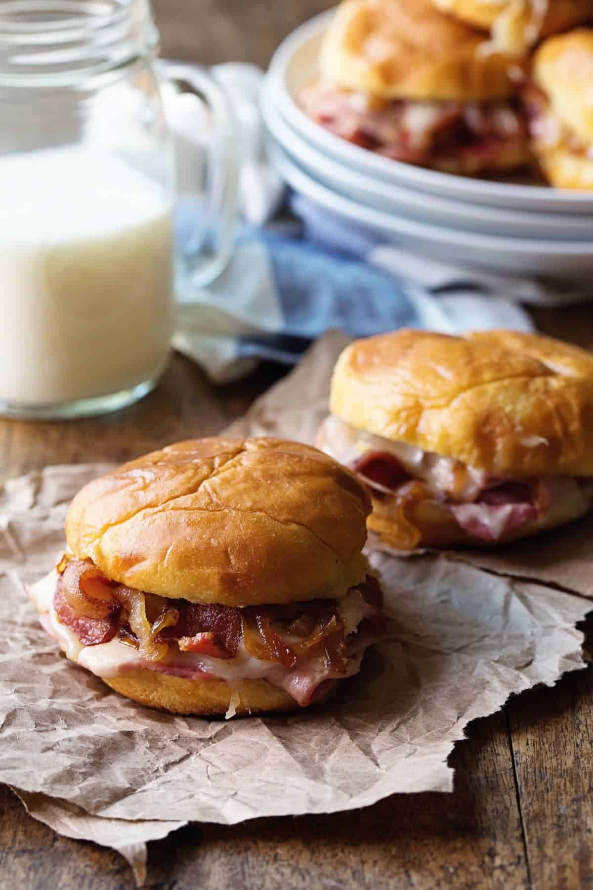 Hot Ham and Cheese Sandwiches on brown paper.
