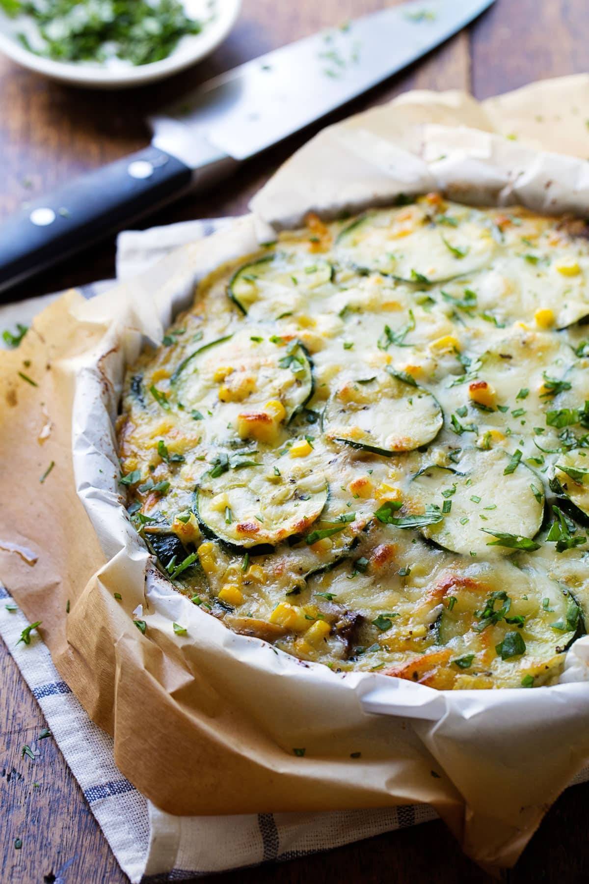 Sweet corn zucchini pie with parchment paper.
