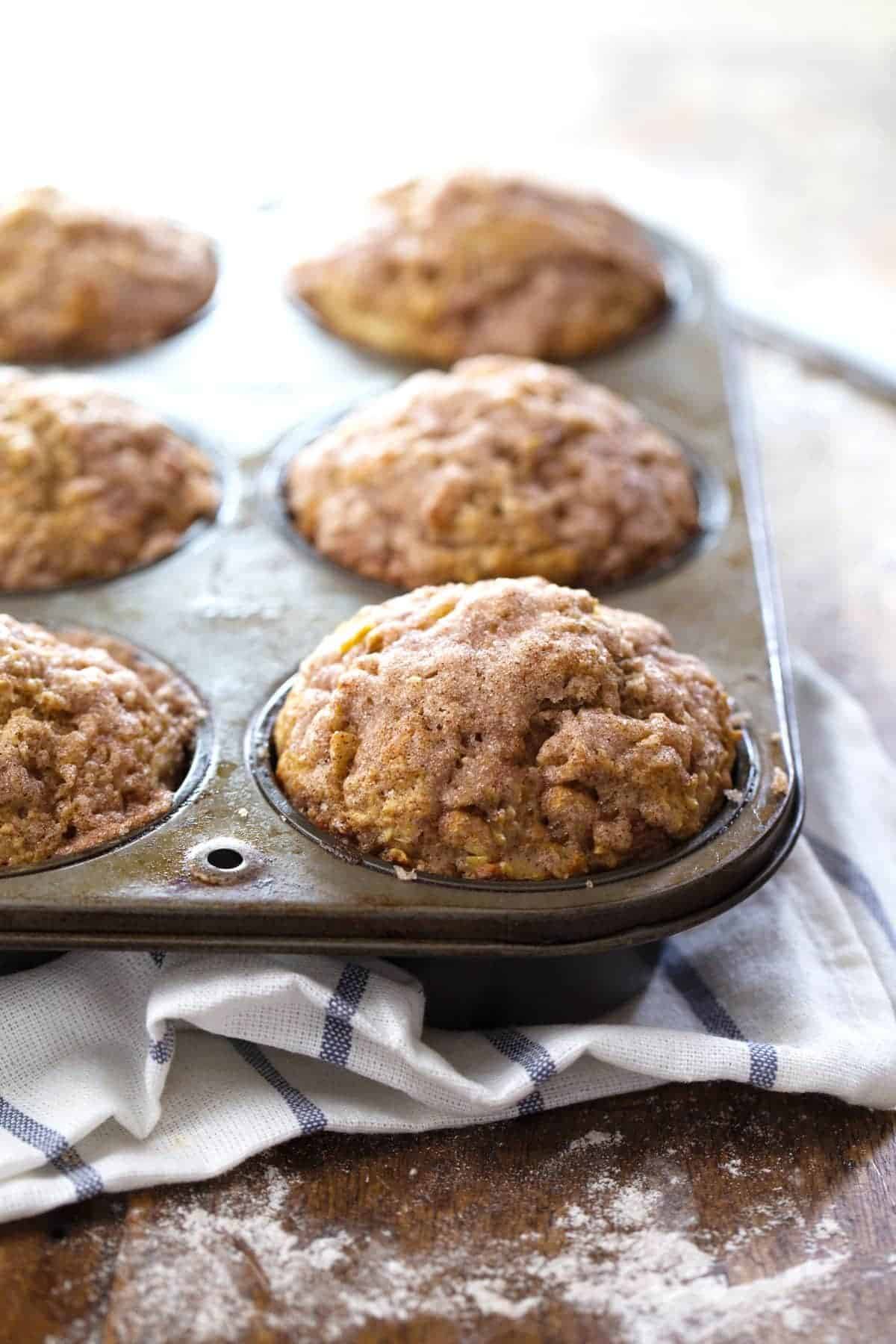 Cinnamon Sugar Apple Muffins in a muffin tin.