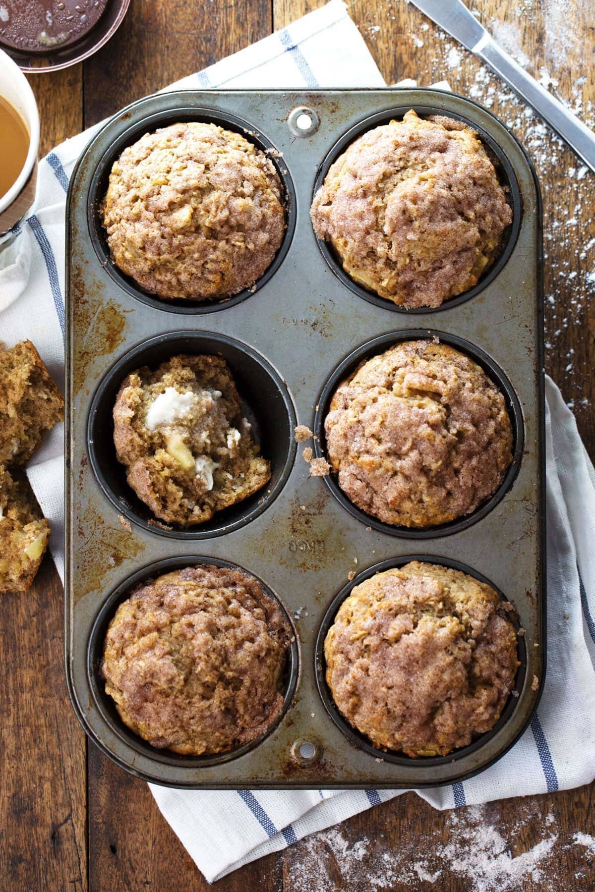 Cinnamon Sugar Apple Muffins in a muffin tin.