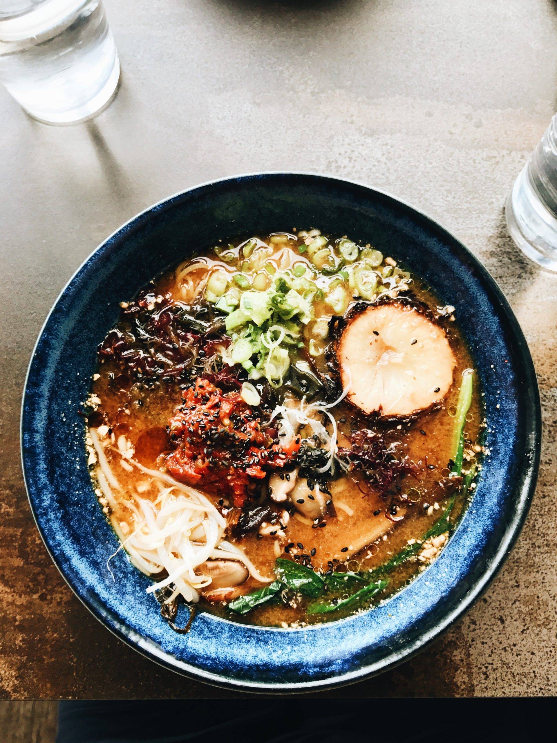 A warm bowl of ramen with tons of goodies on top.