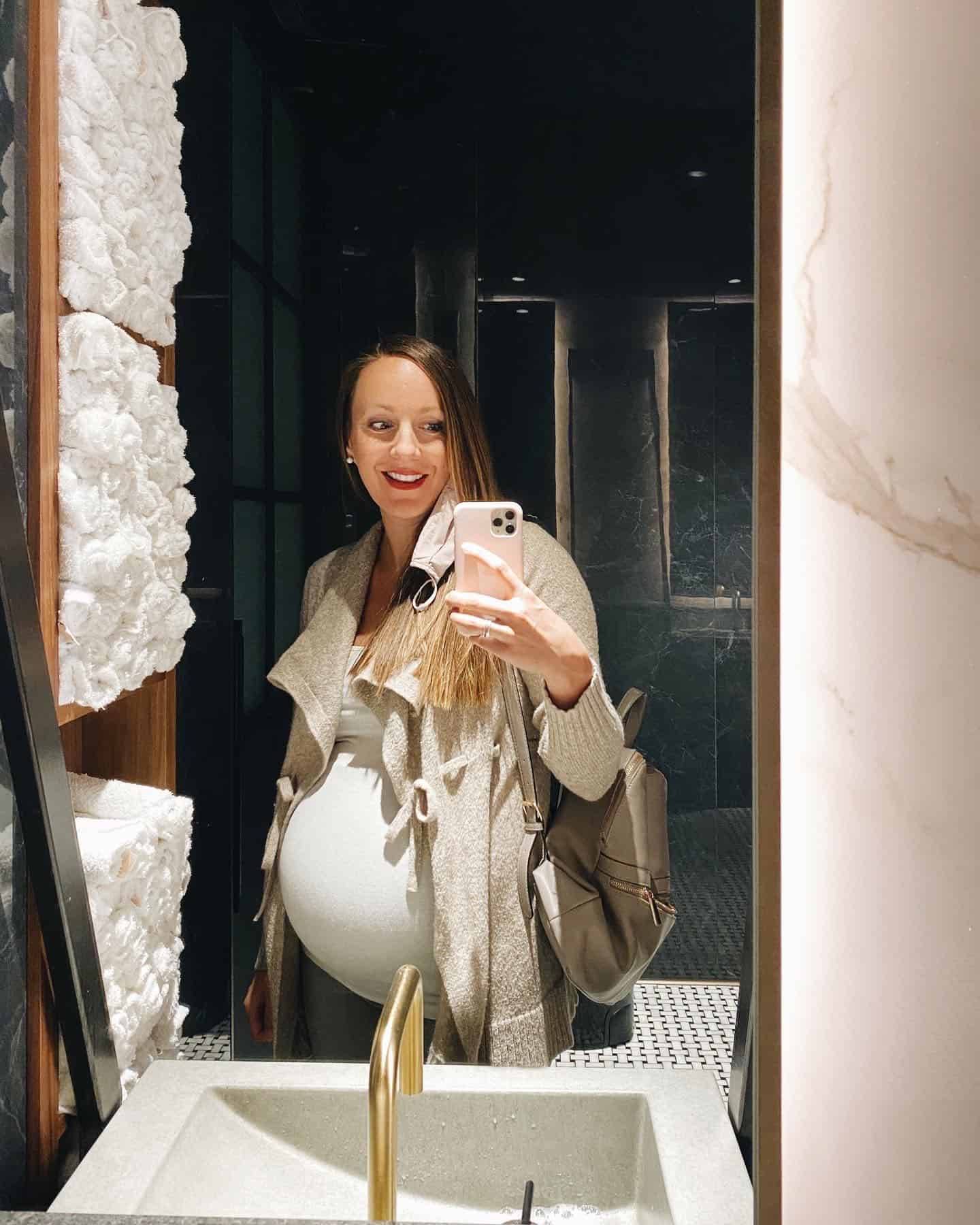 Lindsay takes a selfie in a bathroom mirror.
