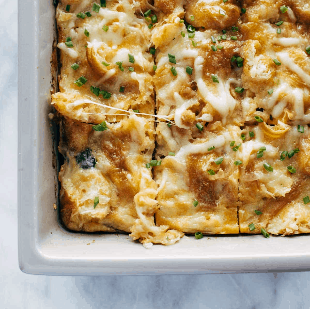 Baked cheesy brunch dish in a tray.