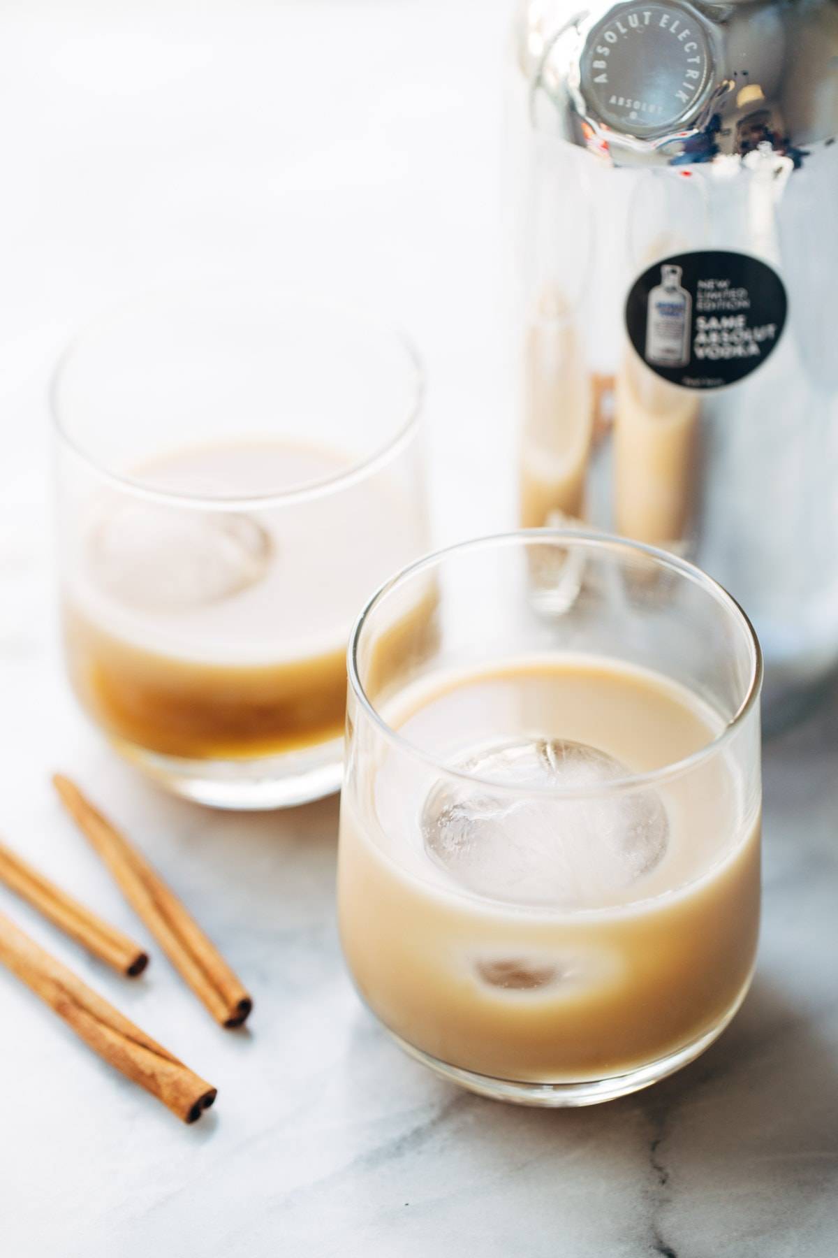 This Cinnamon White Russian is a perfect holiday party drink! with just four ingredients - vodka, coffee liquor, cinnamon simple syrup, and cream. | pinchofyum.com