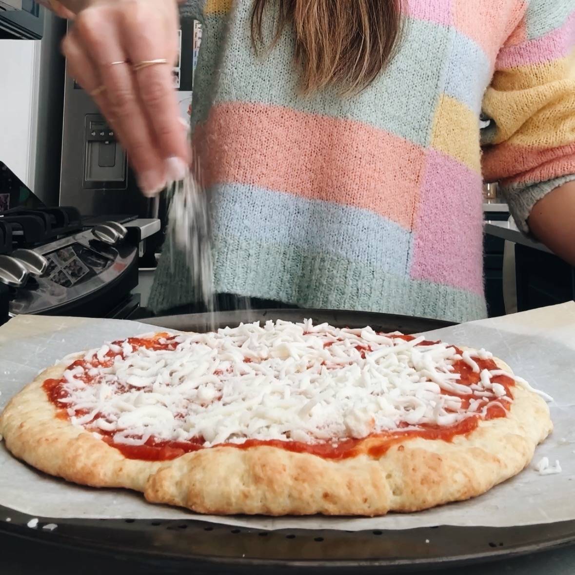 Adding toppings to pre-baked crust.