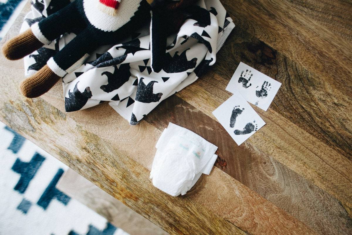 Handmade items and handprints lying on wooden table