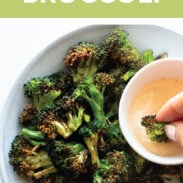 Air fryer broccoli in a bowl with sauce on the side.