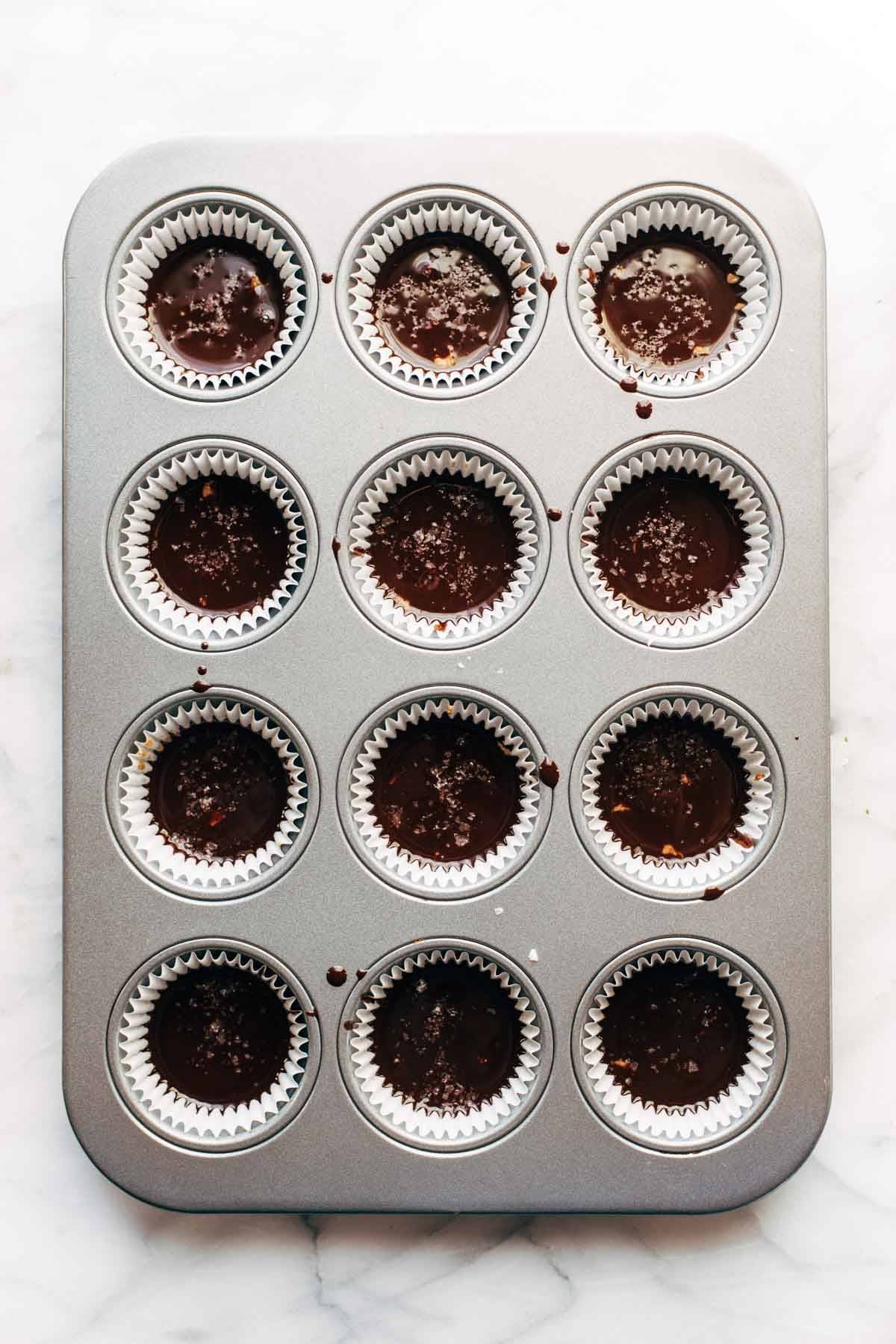 Almond butter cups in muffin pan.