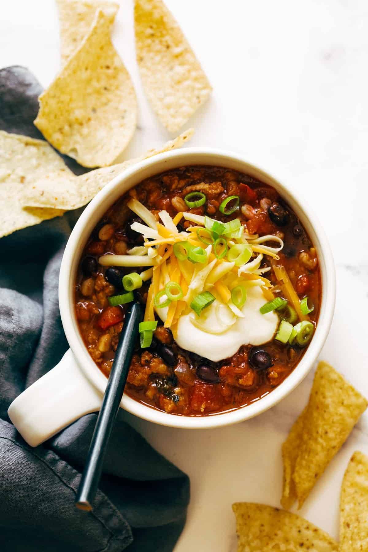Ancho turkey chili in a bowl with toppings.