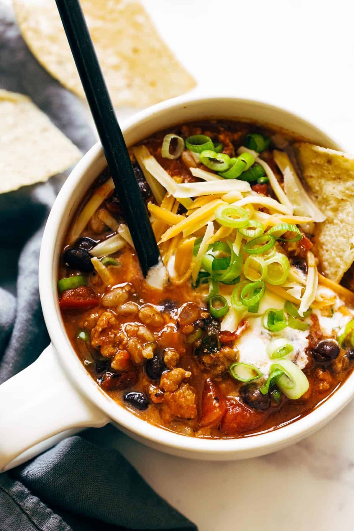 Ancho Turkey Chili in a bowl with toppings.