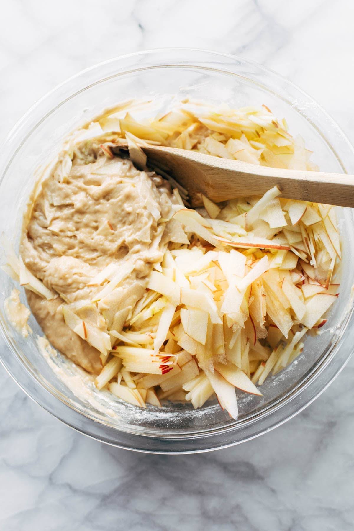 Cake batter with apples in a bowl.