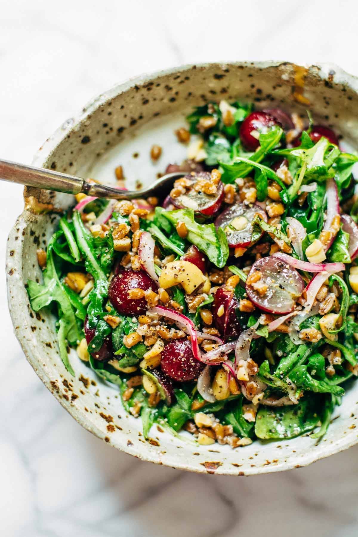 This Arugula Salad has grapes, cashews, pickled red onions, and a simple black pepper vinaigrette. Vegan, vegetarian, gluten free. | pinchofyum.com