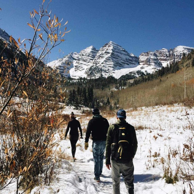 Friends walking in the snowy mountains.