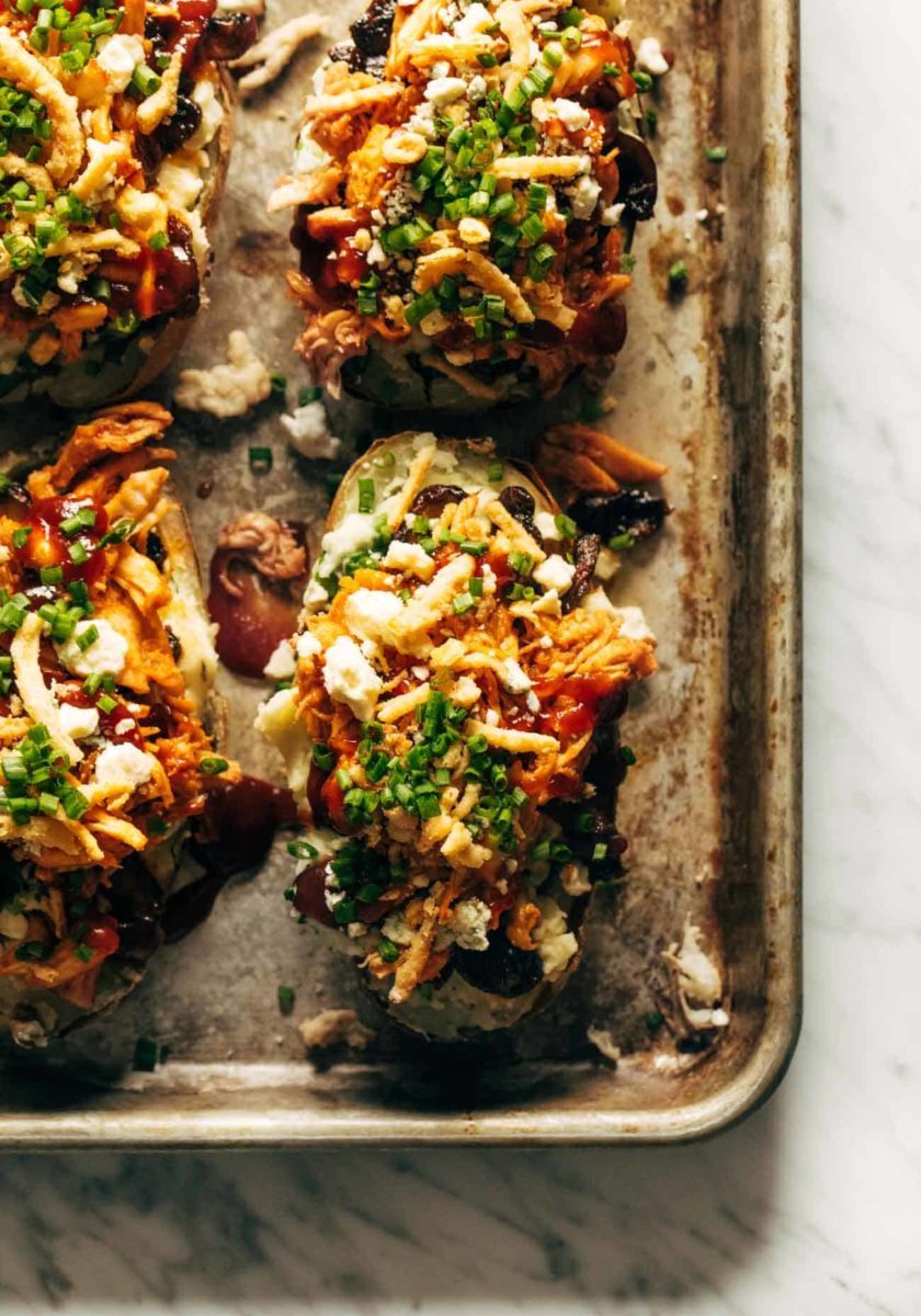 Loaded BBQ Baked Potatoes on a sheet pan.