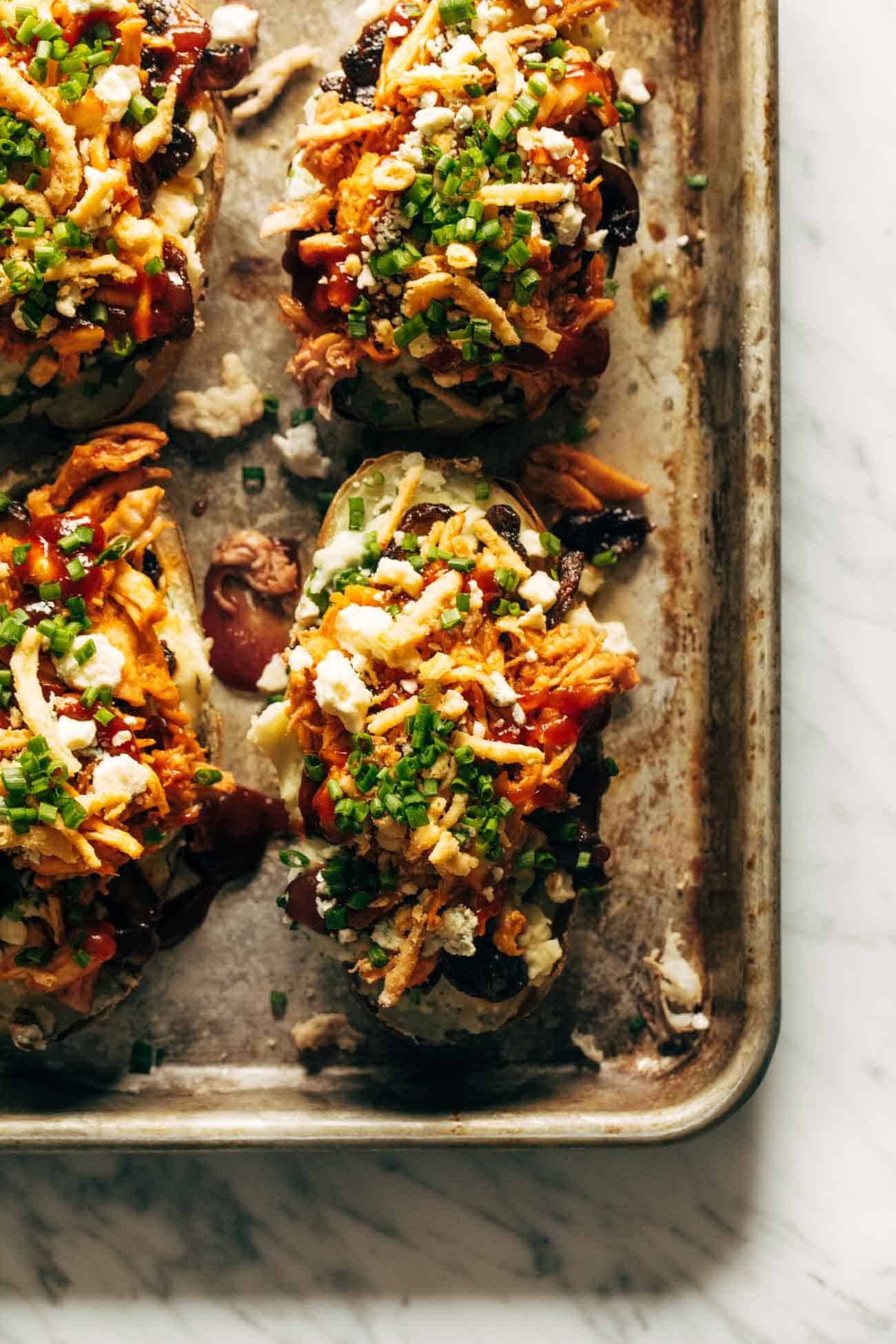 Loaded BBQ Baked Potatoes on a sheet pan. 