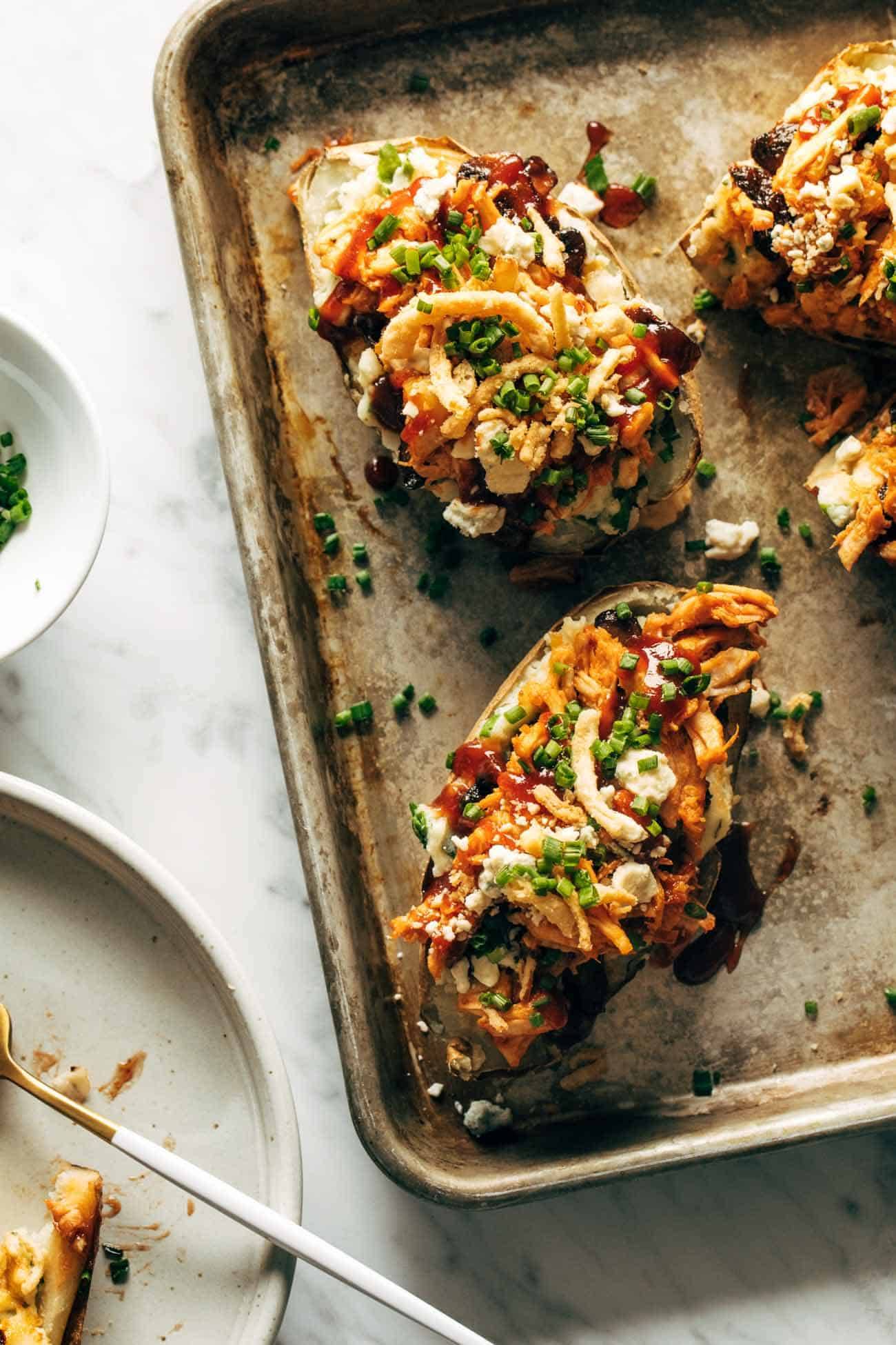 Loaded BBQ Baked Potatoes on a sheet pan.