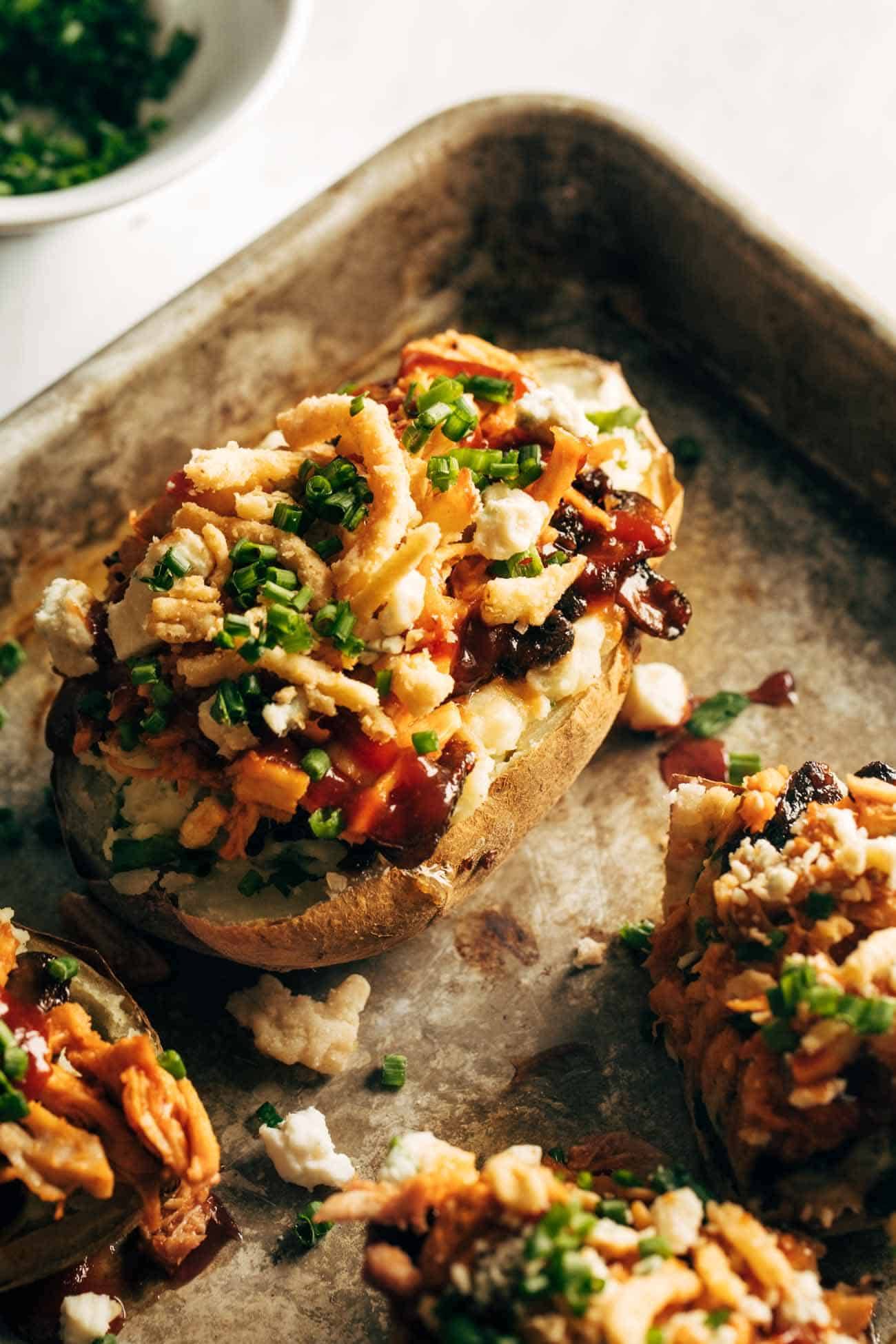 Close-up of Loaded BBQ Baked Potato on a sheet pan. 