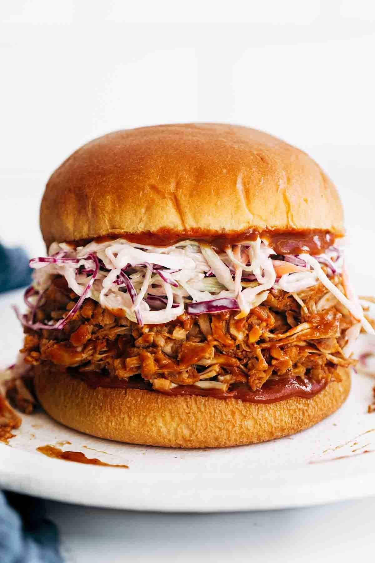 Close-up of BBQ Jackfruit Sandwiches with slaw on a bun. 