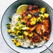 BBQ salmon in a bowl with mango salsa and rice.
