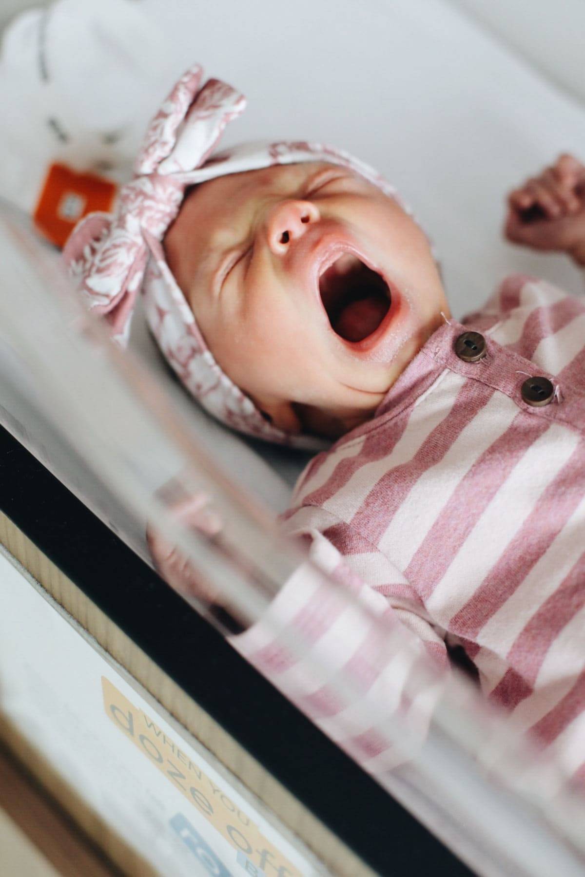 Solvi yawning in the bassinet.