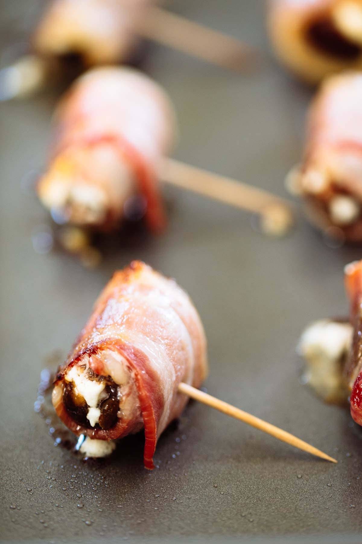 Bacon Wrapped Dates with Goat Cheese on toothpicks.